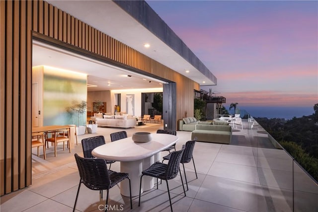 patio terrace at dusk featuring an outdoor hangout area