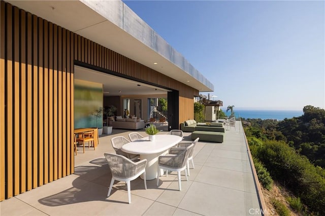 view of patio / terrace with a water view and outdoor lounge area