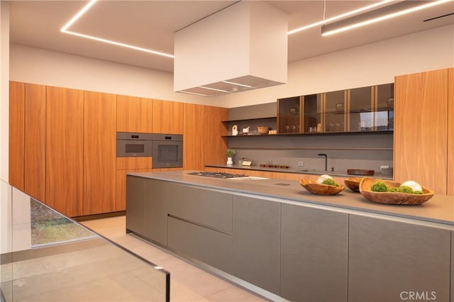 kitchen with light tile patterned floors, appliances with stainless steel finishes, sink, and custom range hood