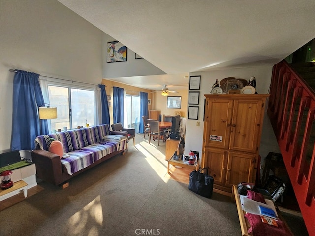 living room with ceiling fan, carpet floors, and vaulted ceiling