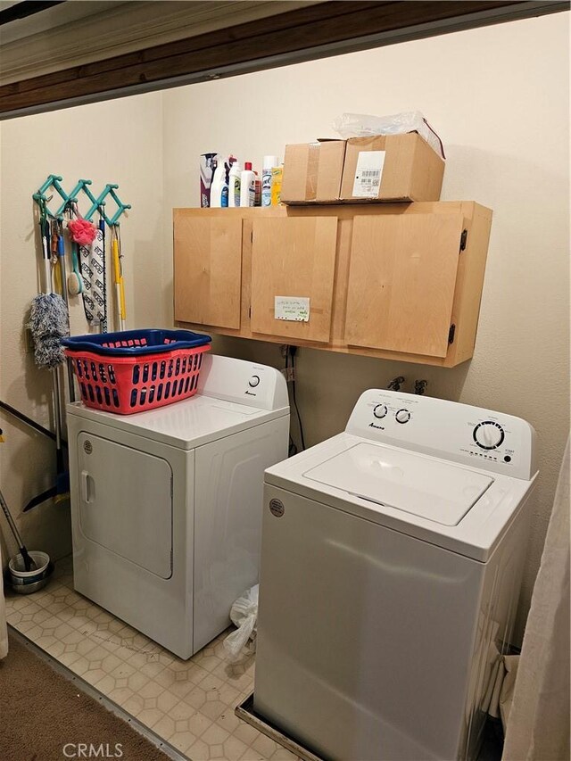 laundry room featuring cabinets and washer and dryer