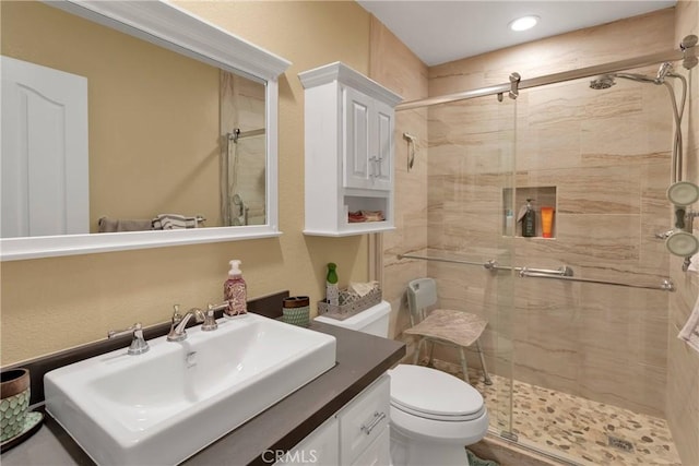 bathroom featuring vanity, toilet, and walk in shower