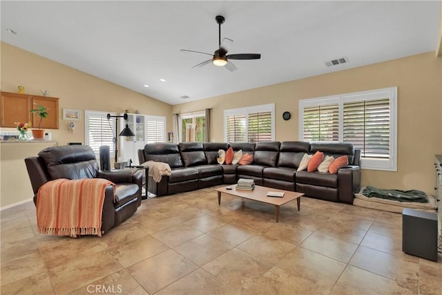 living room featuring ceiling fan, a healthy amount of sunlight, lofted ceiling, and light tile patterned floors