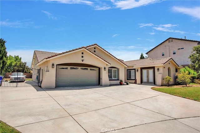 mediterranean / spanish-style home featuring a garage and french doors