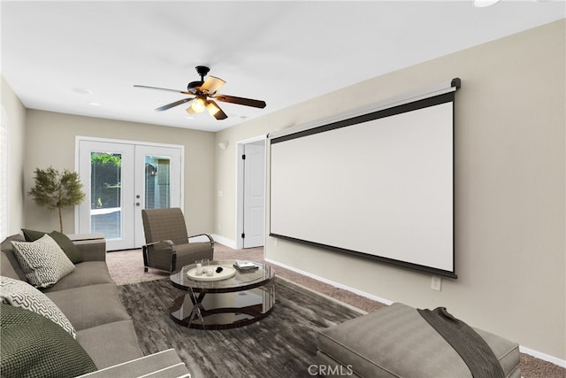 carpeted home theater room with french doors and ceiling fan