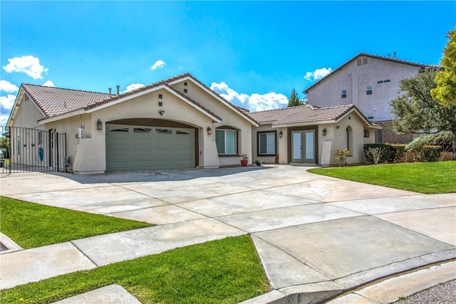 mediterranean / spanish home featuring a tile roof, an attached garage, concrete driveway, and stucco siding