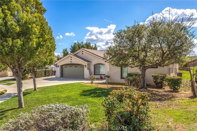 mediterranean / spanish house with stucco siding, concrete driveway, an attached garage, and fence