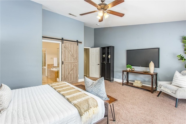 bedroom featuring visible vents, a barn door, carpet flooring, baseboards, and ceiling fan