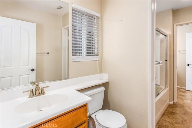 bathroom with vanity, toilet, visible vents, and bath / shower combo with glass door