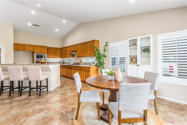 dining space featuring visible vents, recessed lighting, high vaulted ceiling, and baseboards