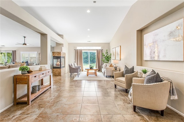 living room with a tiled fireplace, light tile patterned flooring, recessed lighting, and baseboards