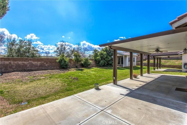 view of patio with a fenced backyard and ceiling fan