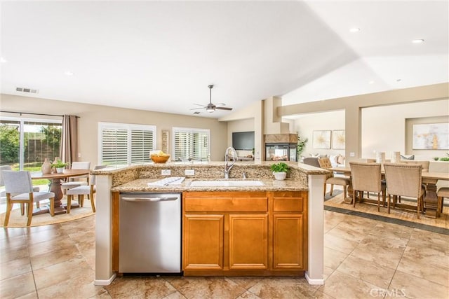kitchen featuring a sink, visible vents, stainless steel dishwasher, and open floor plan