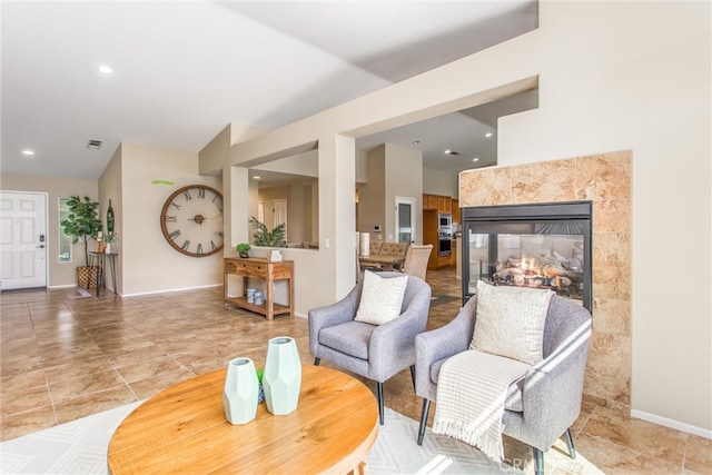 sitting room with recessed lighting, visible vents, baseboards, and a tile fireplace