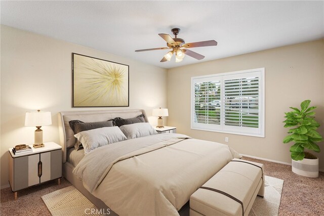 carpeted bedroom featuring a ceiling fan and baseboards