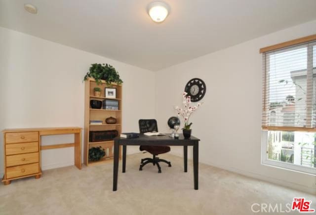 office space with a healthy amount of sunlight and light colored carpet