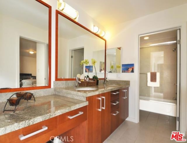 bathroom featuring tile patterned flooring and double sink vanity