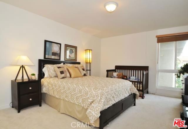 bedroom featuring light carpet