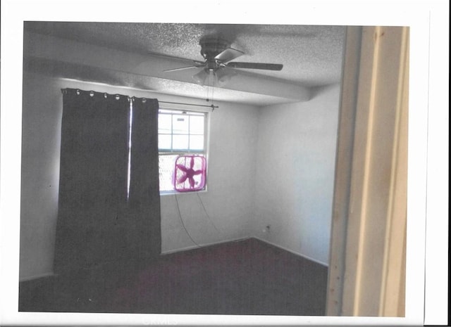 unfurnished room featuring a textured ceiling and ceiling fan