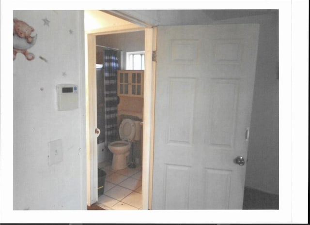 bathroom with tile patterned flooring and toilet