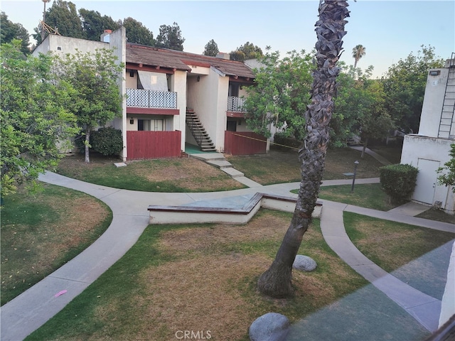 view of home's community featuring a lawn