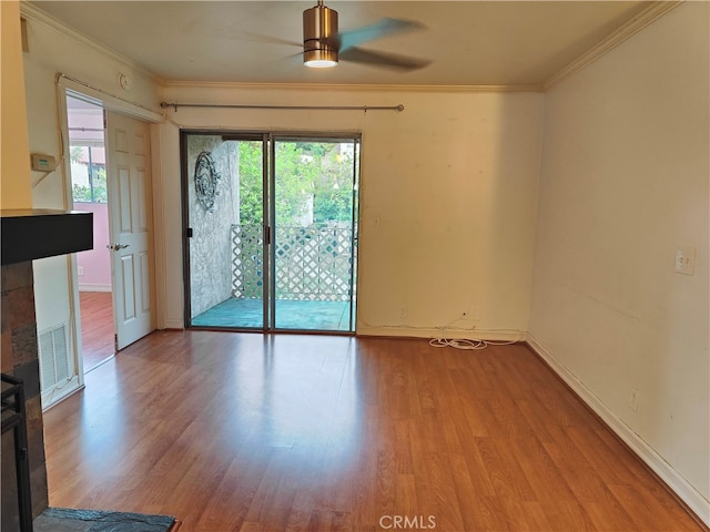 empty room with ceiling fan, hardwood / wood-style floors, and crown molding