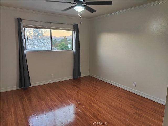 empty room featuring ceiling fan, hardwood / wood-style flooring, and ornamental molding