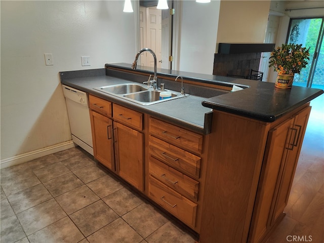 kitchen featuring sink, white dishwasher, kitchen peninsula, and tile patterned flooring