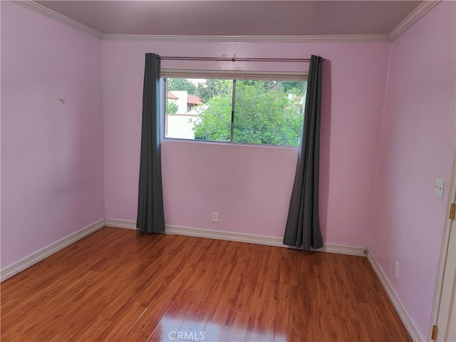 unfurnished room with hardwood / wood-style floors and ornamental molding