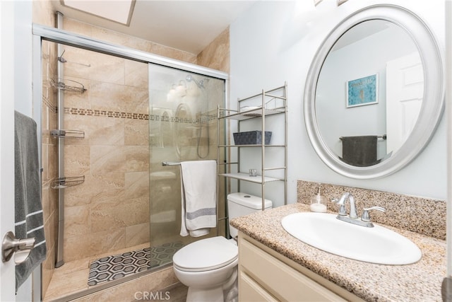 bathroom featuring vanity, toilet, and walk in shower