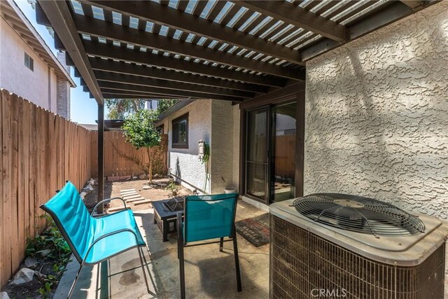 view of patio with cooling unit and a pergola