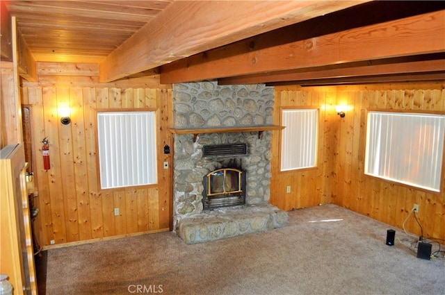 unfurnished living room with carpet flooring, wood walls, wood ceiling, and a fireplace