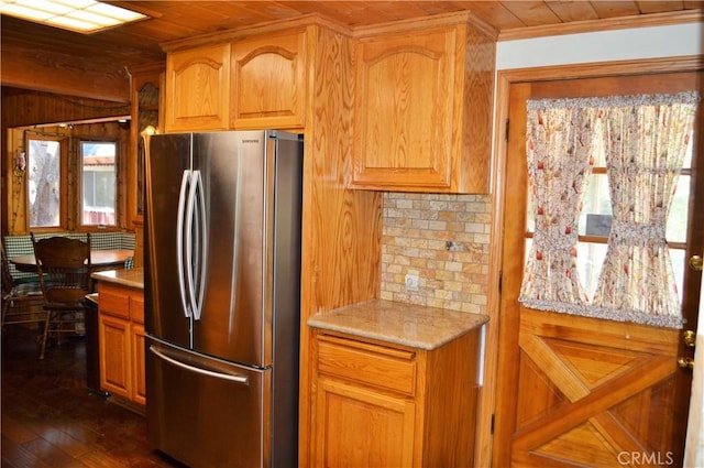 kitchen featuring decorative backsplash, stainless steel fridge, wood ceiling, dark wood-type flooring, and wooden walls