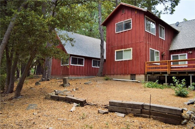 back of house featuring a deck