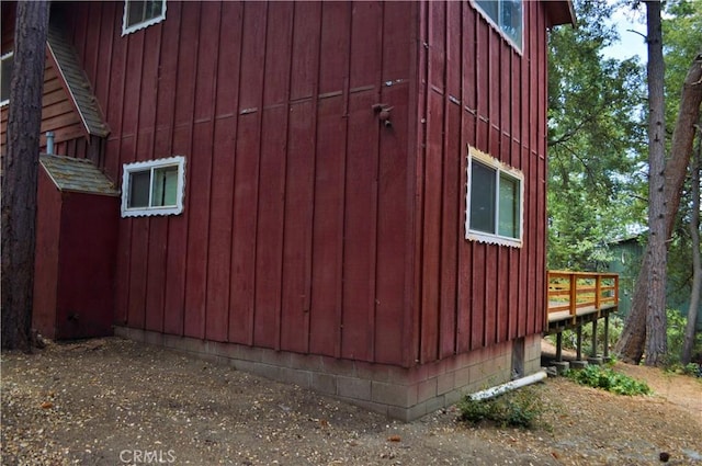 view of home's exterior with a wooden deck