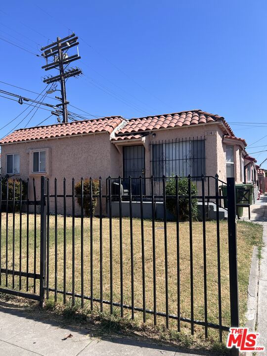 mediterranean / spanish-style home featuring a front lawn