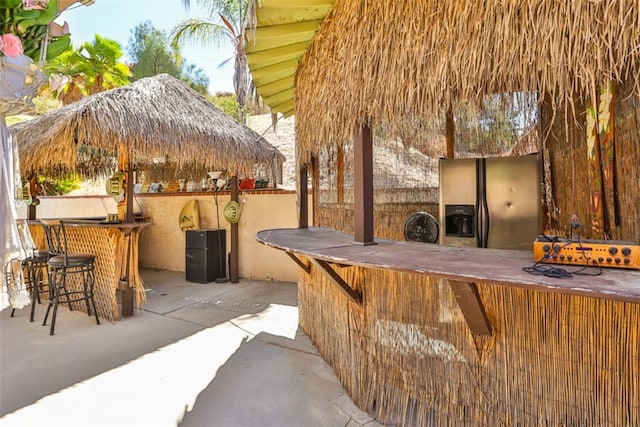 view of patio featuring an outdoor bar