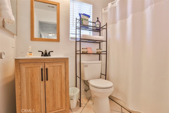 bathroom featuring tile patterned floors, vanity, and toilet