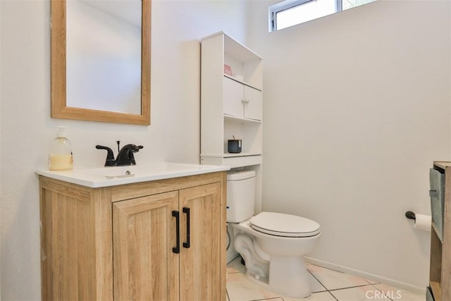 bathroom featuring tile patterned flooring, vanity, and toilet