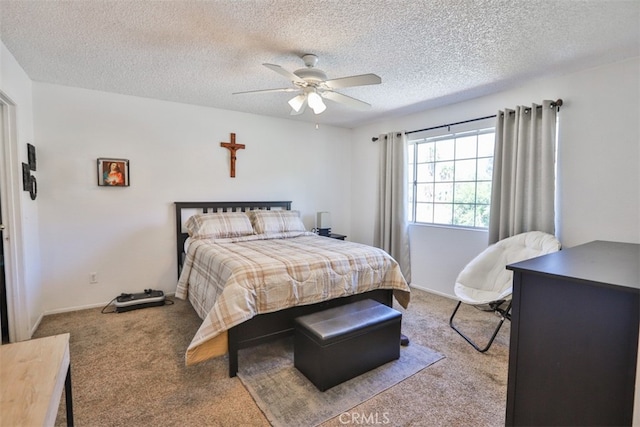 carpeted bedroom featuring ceiling fan and a textured ceiling