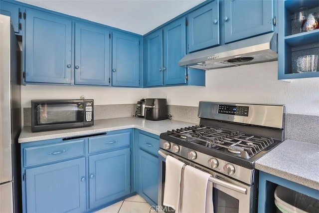 kitchen featuring blue cabinetry, light tile patterned floors, and stainless steel appliances