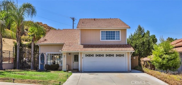 view of front of house featuring a garage and a front lawn