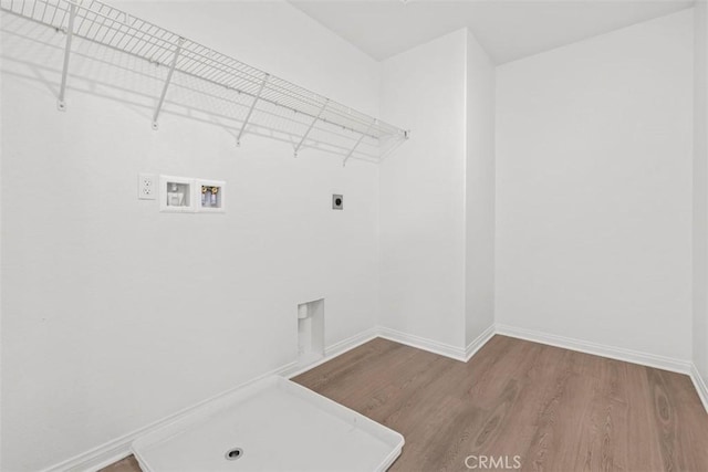 clothes washing area with electric dryer hookup, hardwood / wood-style floors, and hookup for a washing machine