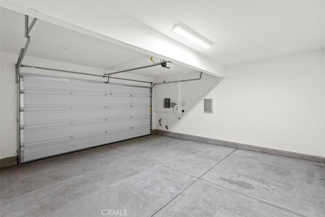 garage with a garage door opener and electric panel