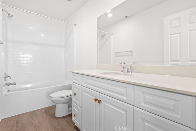 full bathroom with wood-type flooring, toilet, shower / bath combination, and vanity