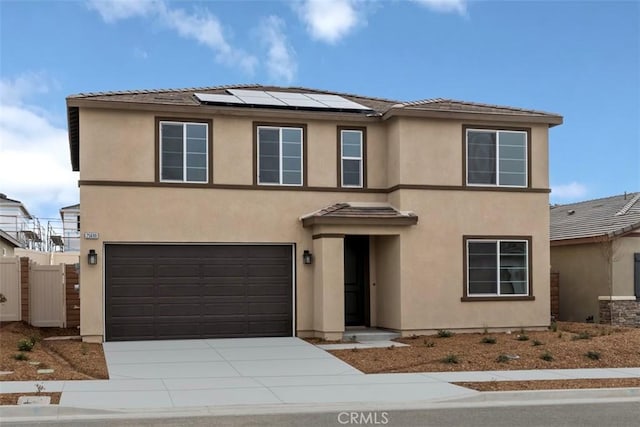 view of front facade featuring a garage and solar panels