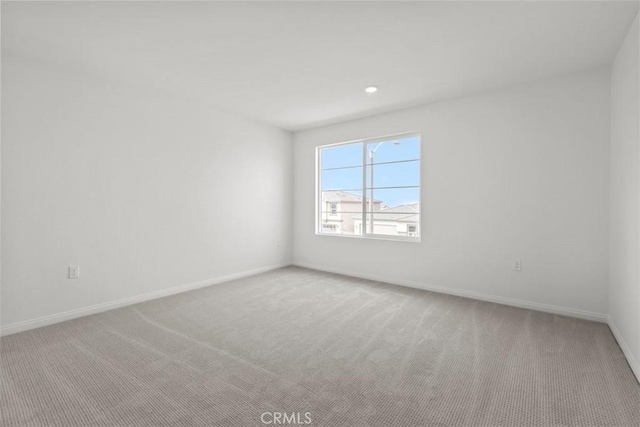 empty room featuring light colored carpet