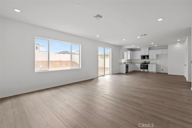 unfurnished living room with light wood-type flooring