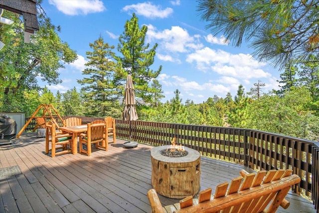 wooden terrace featuring a fire pit