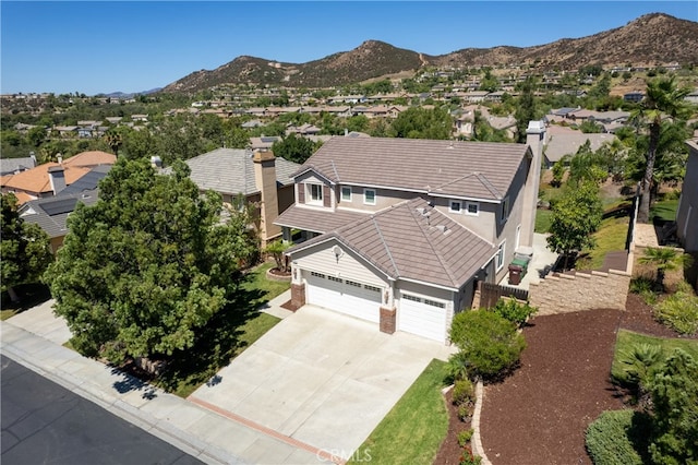 birds eye view of property with a mountain view